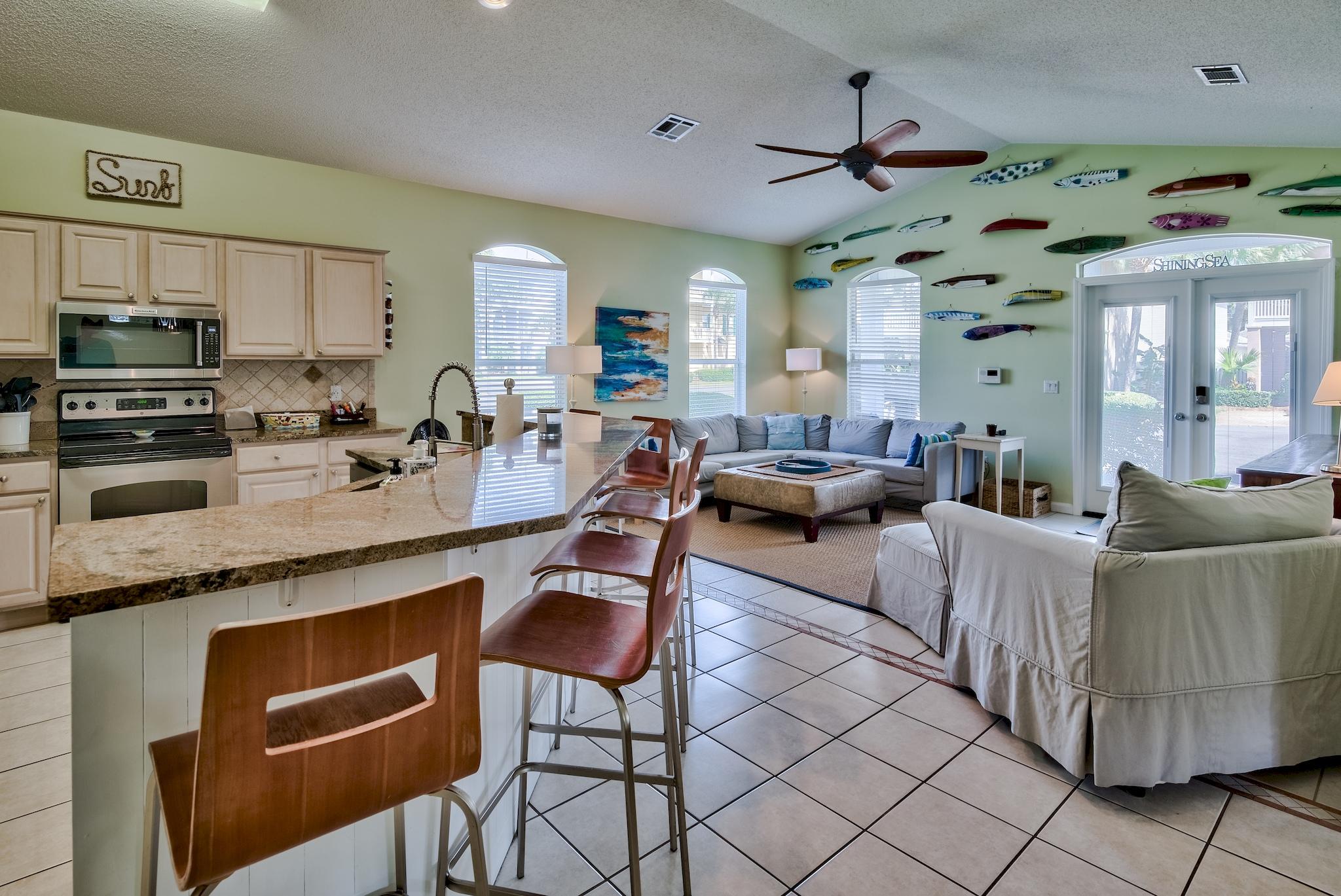 16 Ruby Cove Miramar Beach, FL 32550 - Photo 12 of 40 a living room with furniture a flat screen tv and kitchen view