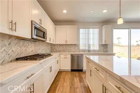434 Harding Road Corona, CA 92879 - Photo 31 of 44 a kitchen with stainless steel appliances granite countertop a stove a sink and a microwave