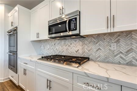 434 Harding Road Corona, CA 92879 - Photo 33 of 44 a kitchen with granite countertop a stove and a microwave