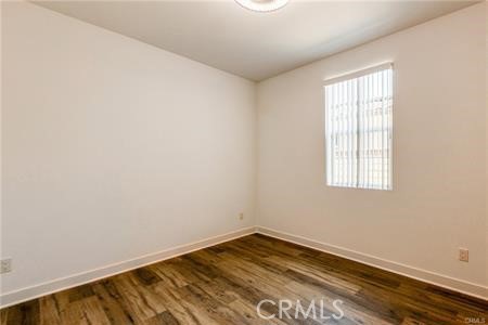 434 Harding Road Corona, CA 92879 - Photo 37 of 44 an empty room with wooden floor and windows