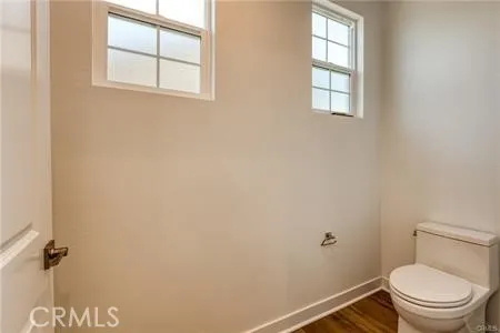 a white toilet sitting next to a window