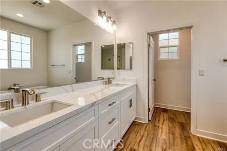 a bathroom with a sink a mirror and a bathtub