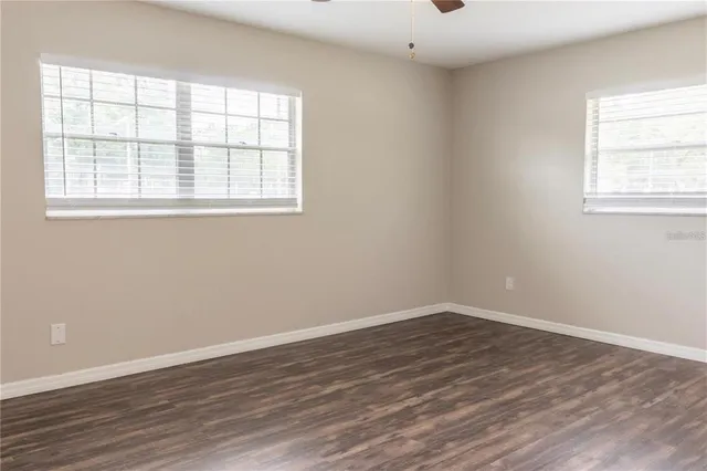 wooden floor in an empty room with a window