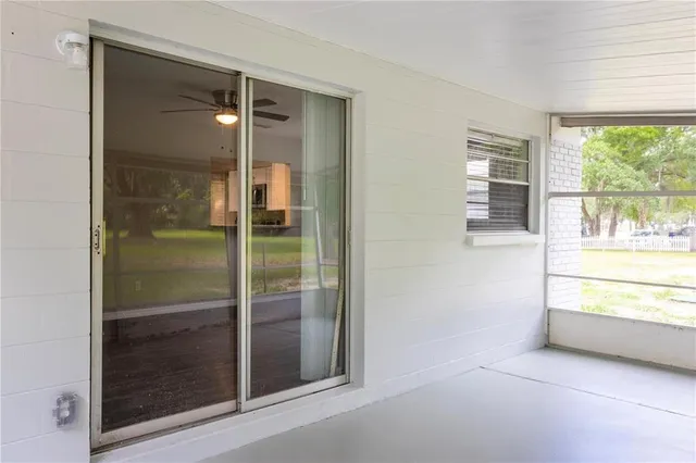 a bathroom with a glass shower door and a window