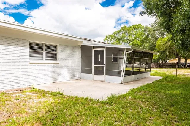 a view of a house with backyard and porch