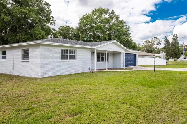 a view of a house with a backyard