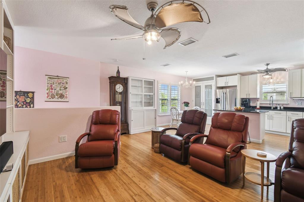 3227 Rose Arbor Drive Hernando Beach, FL 34607 - Photo 16 of 52 a living room with furniture or couch and a bookshelf