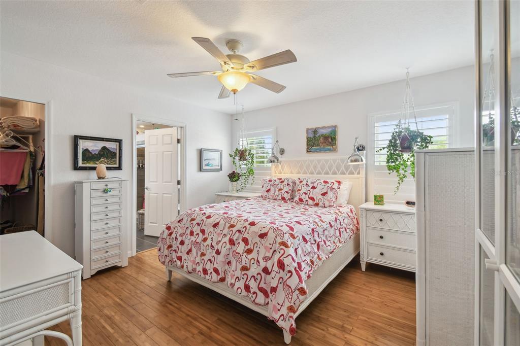 3227 Rose Arbor Drive Hernando Beach, FL 34607 - Photo 18 of 52 a bedroom with a bed and a chandelier