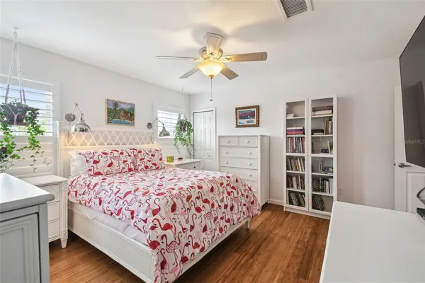 a bedroom with a large bed and a chandelier