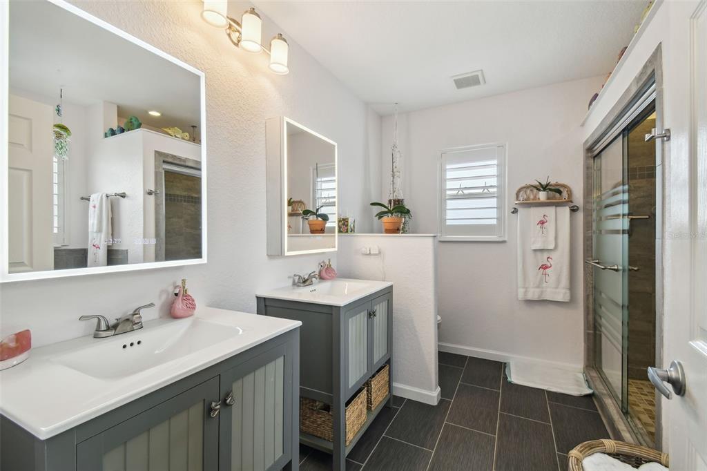 3227 Rose Arbor Drive Hernando Beach, FL 34607 - Photo 20 of 52 a bathroom with a double vanity sink mirror and toilet