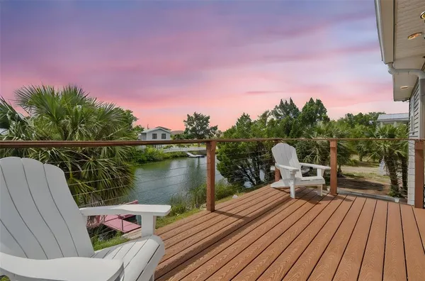 a view of a deck with chairs and wooden floor