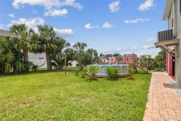 a view of a house with a backyard and a patio