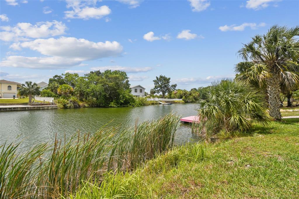 3227 Rose Arbor Drive Hernando Beach, FL 34607 - Photo 3 of 52 a view of a lake with houses in the back