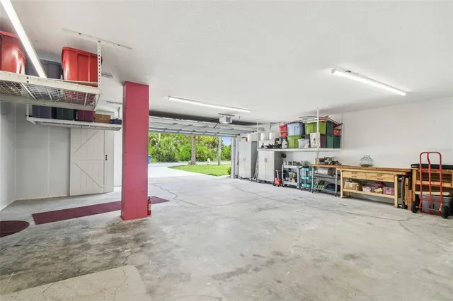 a work room with furniture and a flat screen tv
