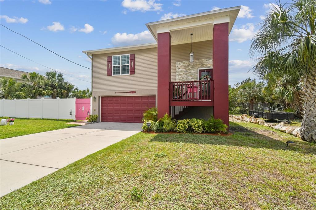 3227 Rose Arbor Drive Hernando Beach, FL 34607 - Photo 4 of 52 a front view of a house with garden