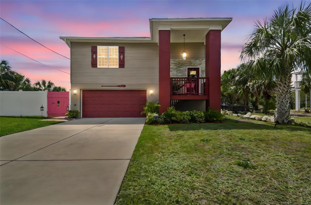 3227 Rose Arbor Drive Hernando Beach, FL 34607 - Photo 45 of 52 a view of a house with a yard and a garage