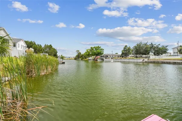 a view of house with swimming pool and outdoor seating
