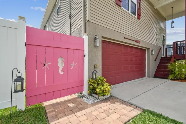 a view of backyard with brick wall and potted plants