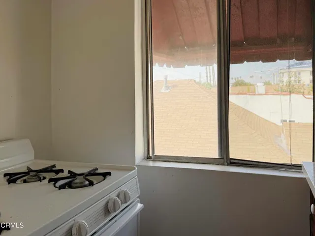 a kitchen that has a stove and a window