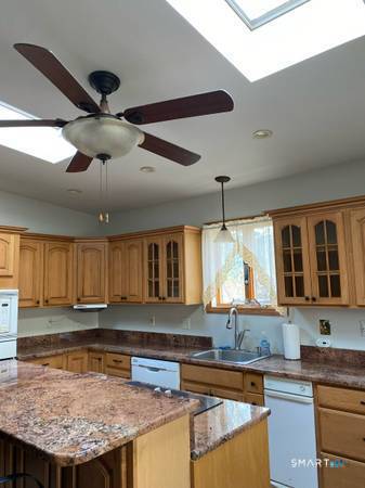 134 Delaware Road Easton, CT 06612 - Photo 4 of 7 a kitchen with stainless steel appliances granite countertop a sink a stove and a wooden cabinets