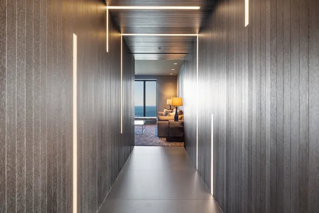 a living room with furniture and large windows