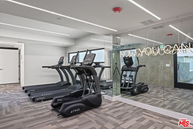 a kitchen with stainless steel appliances a stove microwave and sink