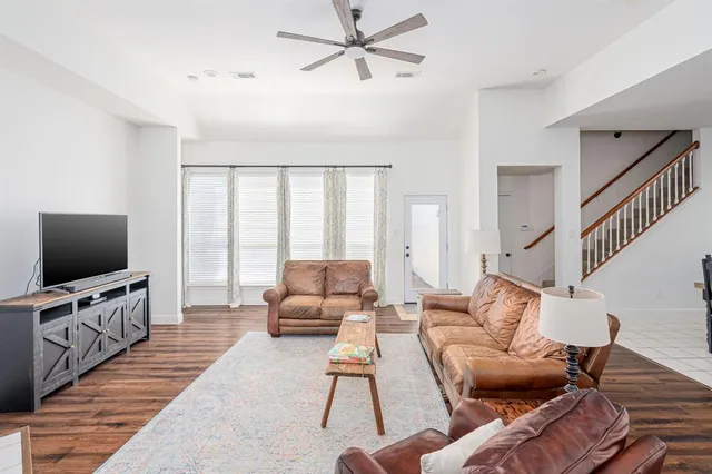 a living room with furniture and kitchen view