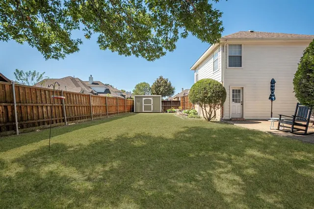 a front view of house with yard and trees