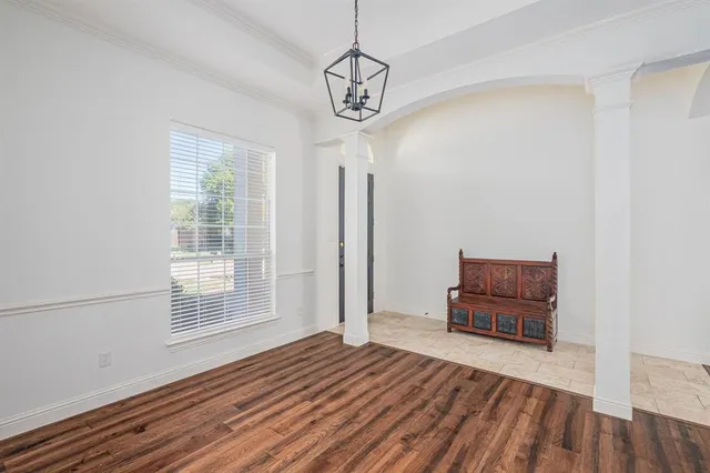 a view of a room with wooden floor and white walls