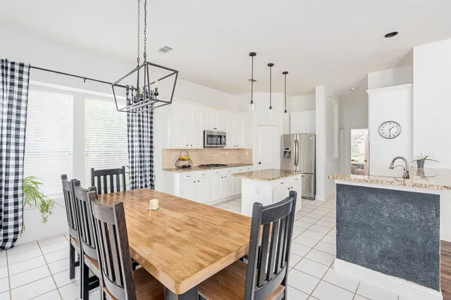 a kitchen with a stove a refrigerator and a sink