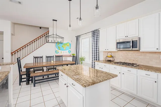 a view of a hallway with wooden floor and stairs