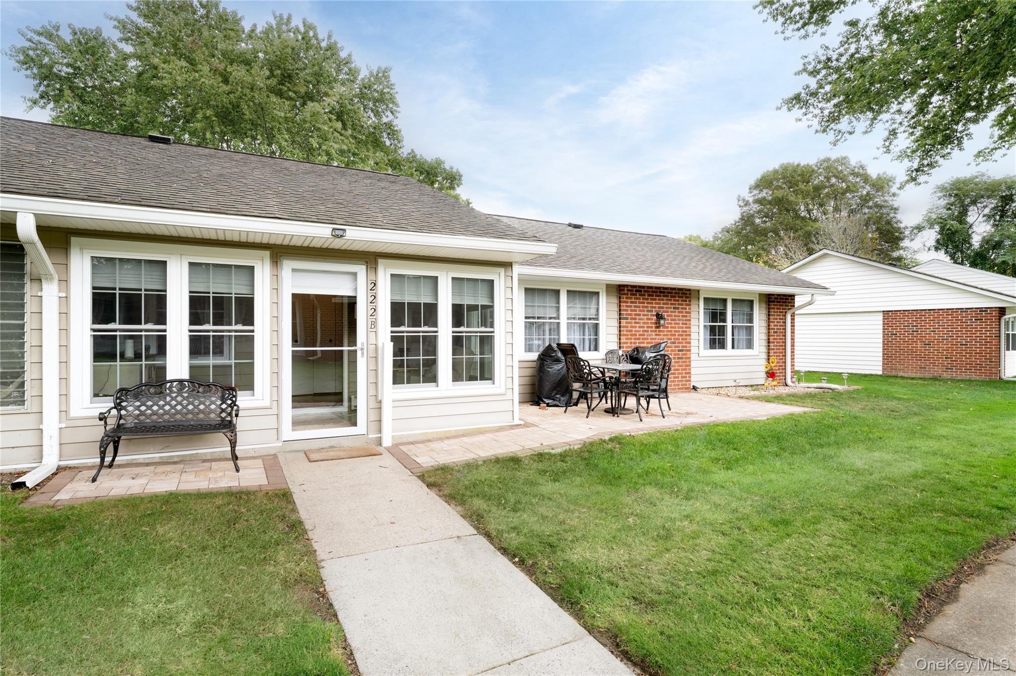 Front view of house a spacious paver patio.