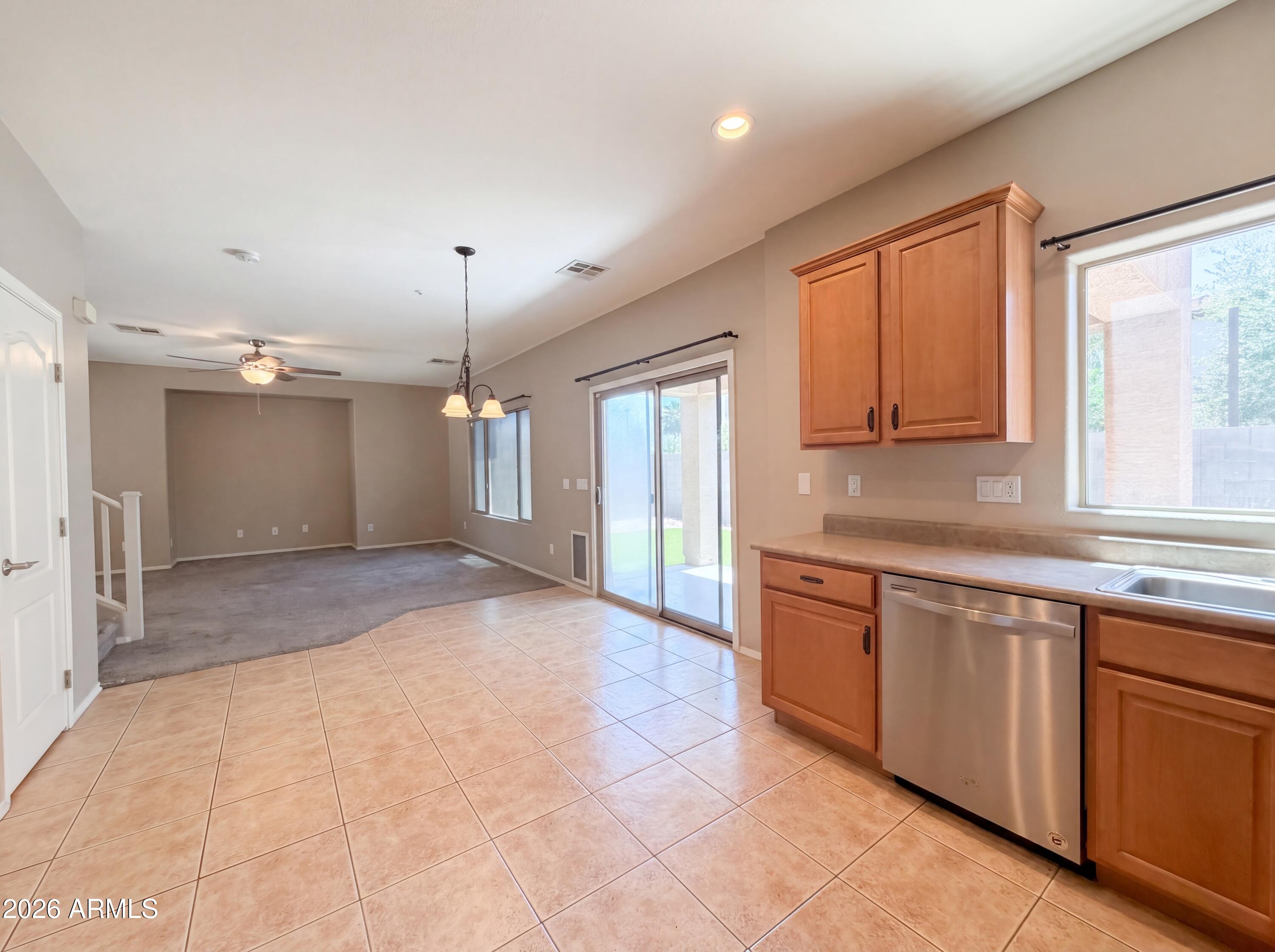 1565 East Hopkins Road Gilbert, AZ 85295 - Photo 6 of 29 a large kitchen with kitchen island granite countertop a sink window and cabinets