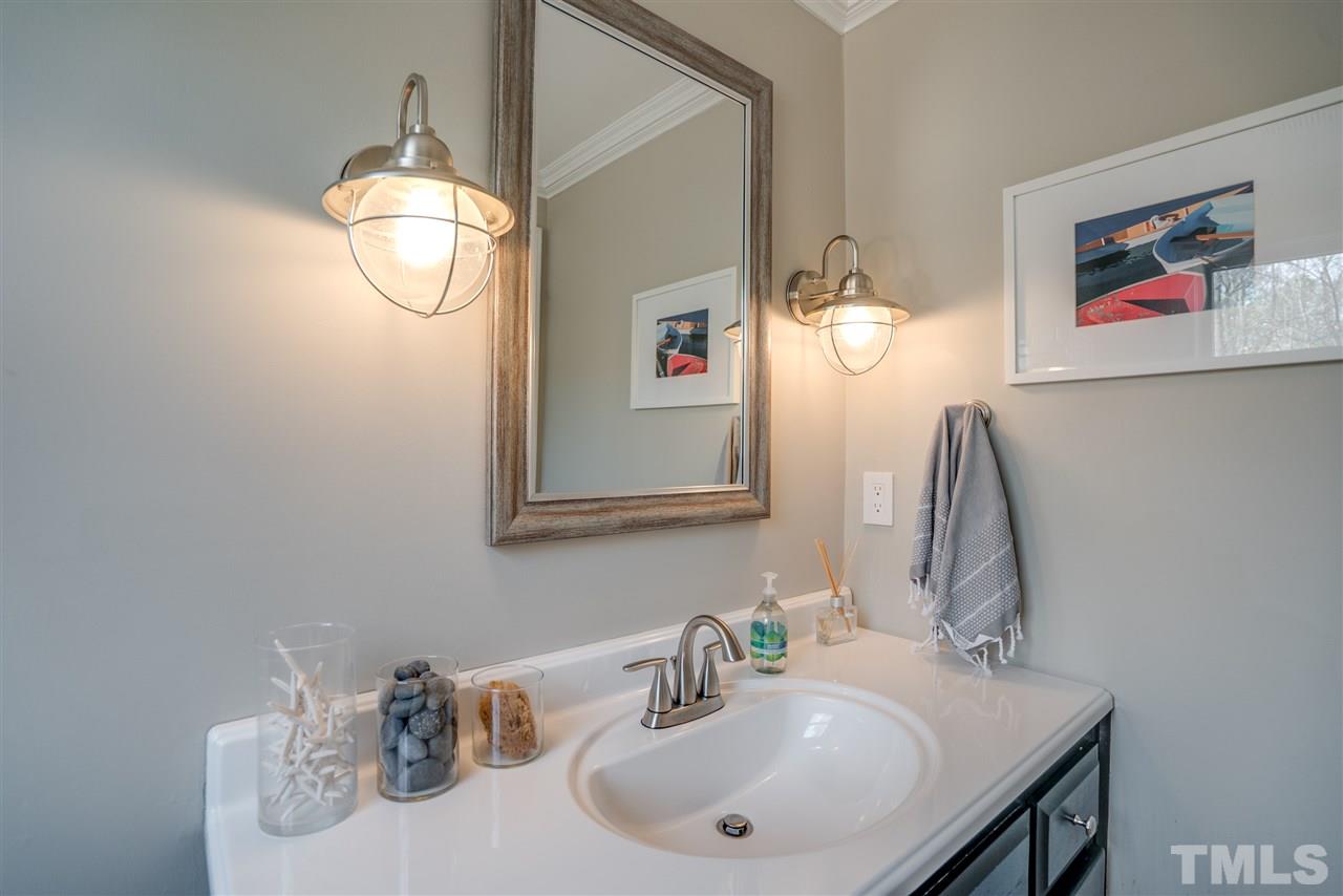 5624 North Hawthorne Way Raleigh, NC 27613 - Photo 14 of 25 a bathroom with a sink and a mirror