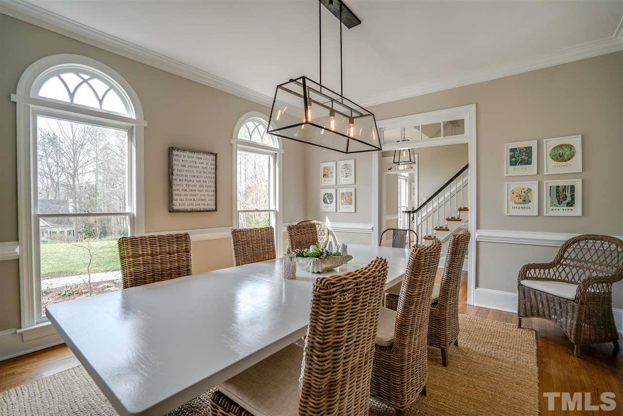 5624 North Hawthorne Way Raleigh, NC 27613 - Photo 3 of 25 a view of a livingroom with furniture wooden floor and a floor to ceiling window