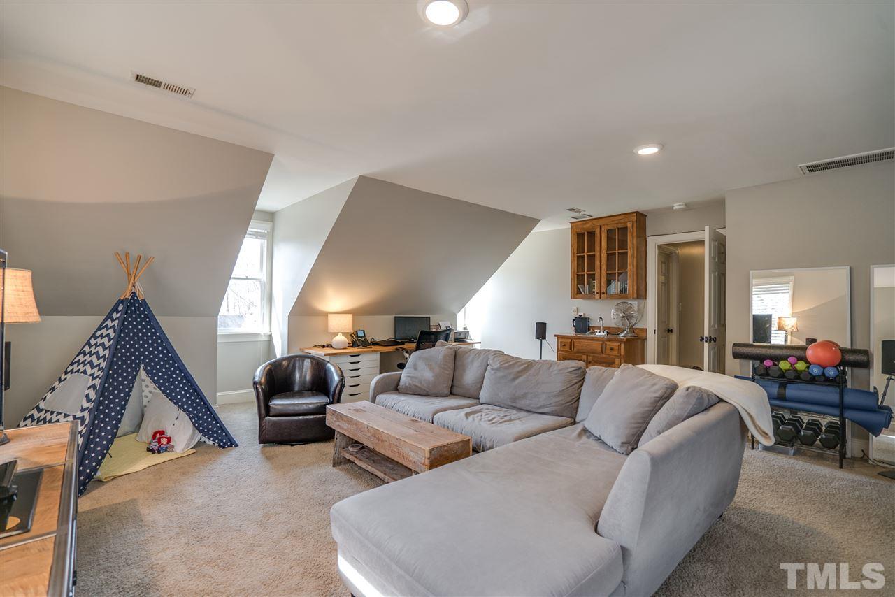 5624 North Hawthorne Way Raleigh, NC 27613 - Photo 22 of 25 a living room with furniture and a wooden floor