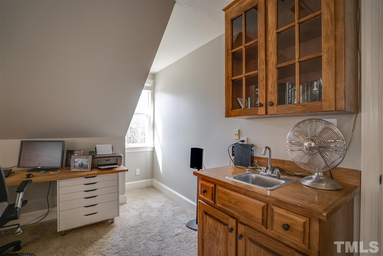 5624 North Hawthorne Way Raleigh, NC 27613 - Photo 23 of 25 a kitchen with a sink and cabinets
