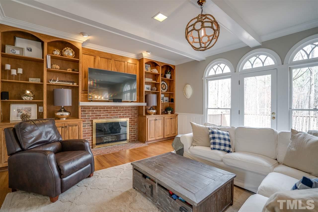 5624 North Hawthorne Way Raleigh, NC 27613 - Photo 6 of 25 a living room with furniture a fireplace and a flat screen tv