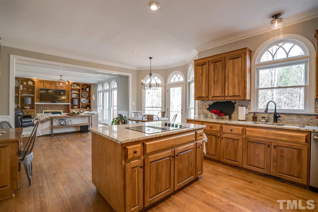 5624 North Hawthorne Way Raleigh, NC 27613 - Photo 9 of 25 a kitchen with lots of counter top space and dining table