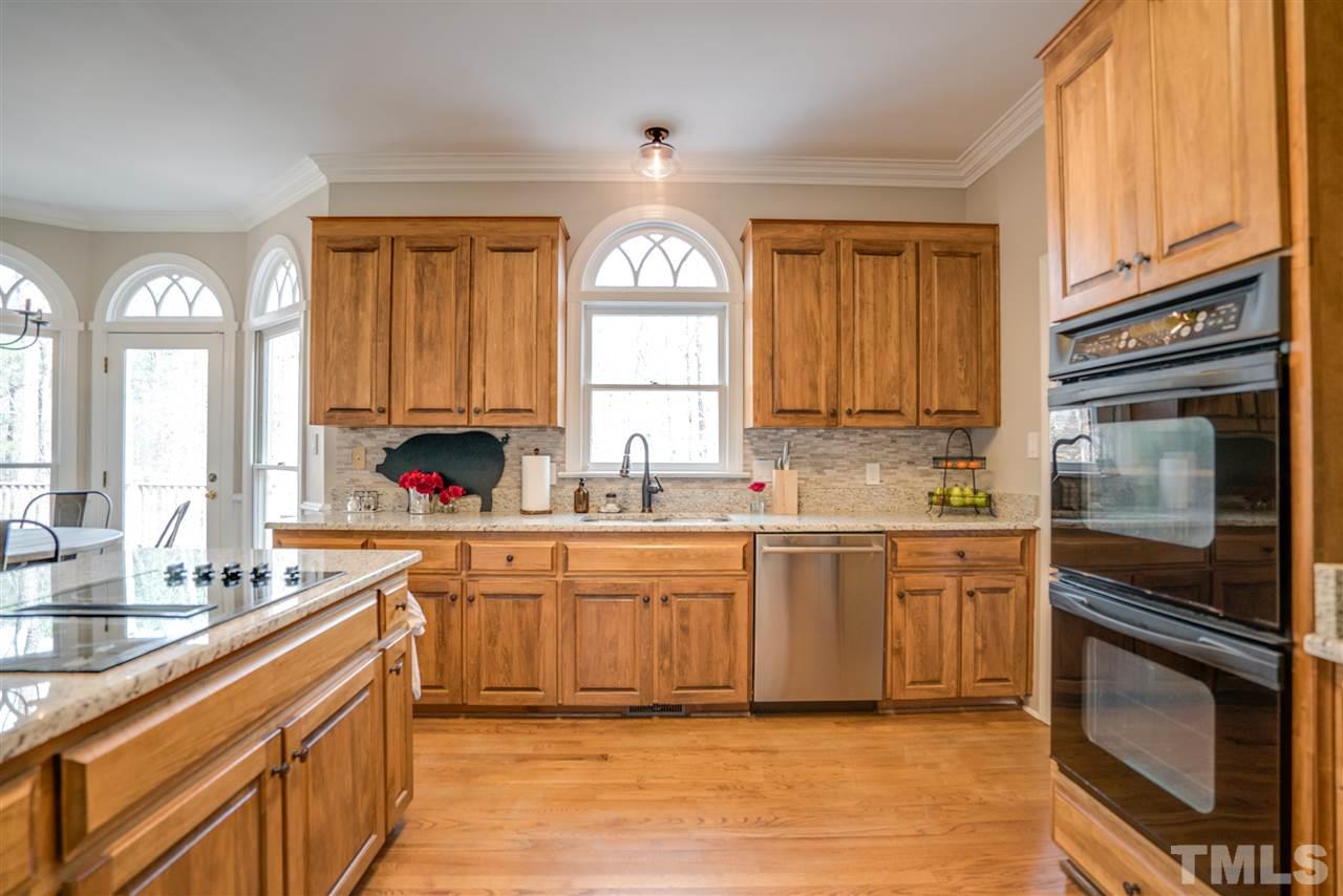 5624 North Hawthorne Way Raleigh, NC 27613 - Photo 10 of 25 a kitchen with stainless steel appliances granite countertop a stove a sink and a microwave