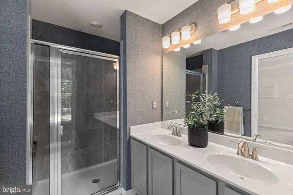 a bathroom with a shower sink and mirror