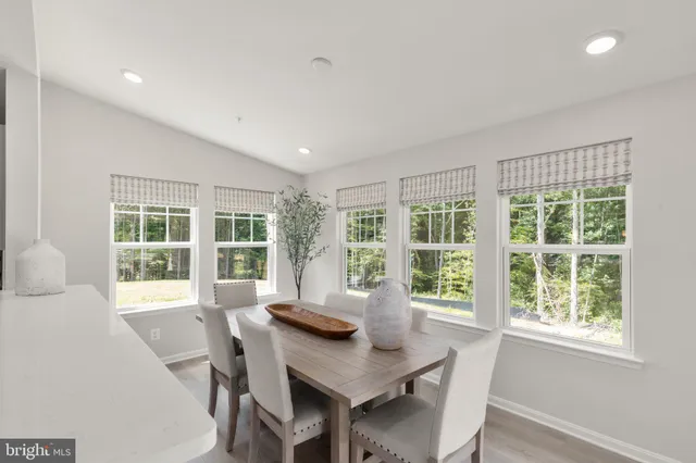 a view of a dining room with furniture large windows and wooden floor