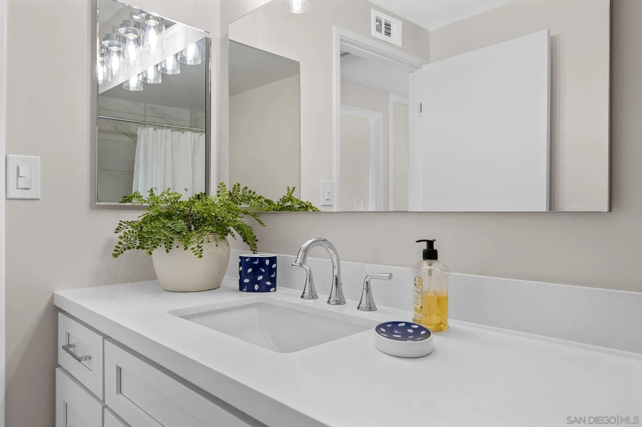 3252 Eichenlaub Street San Diego, CA 92117 - Photo 13 of 36 a kitchen with a sink and a white cabinets