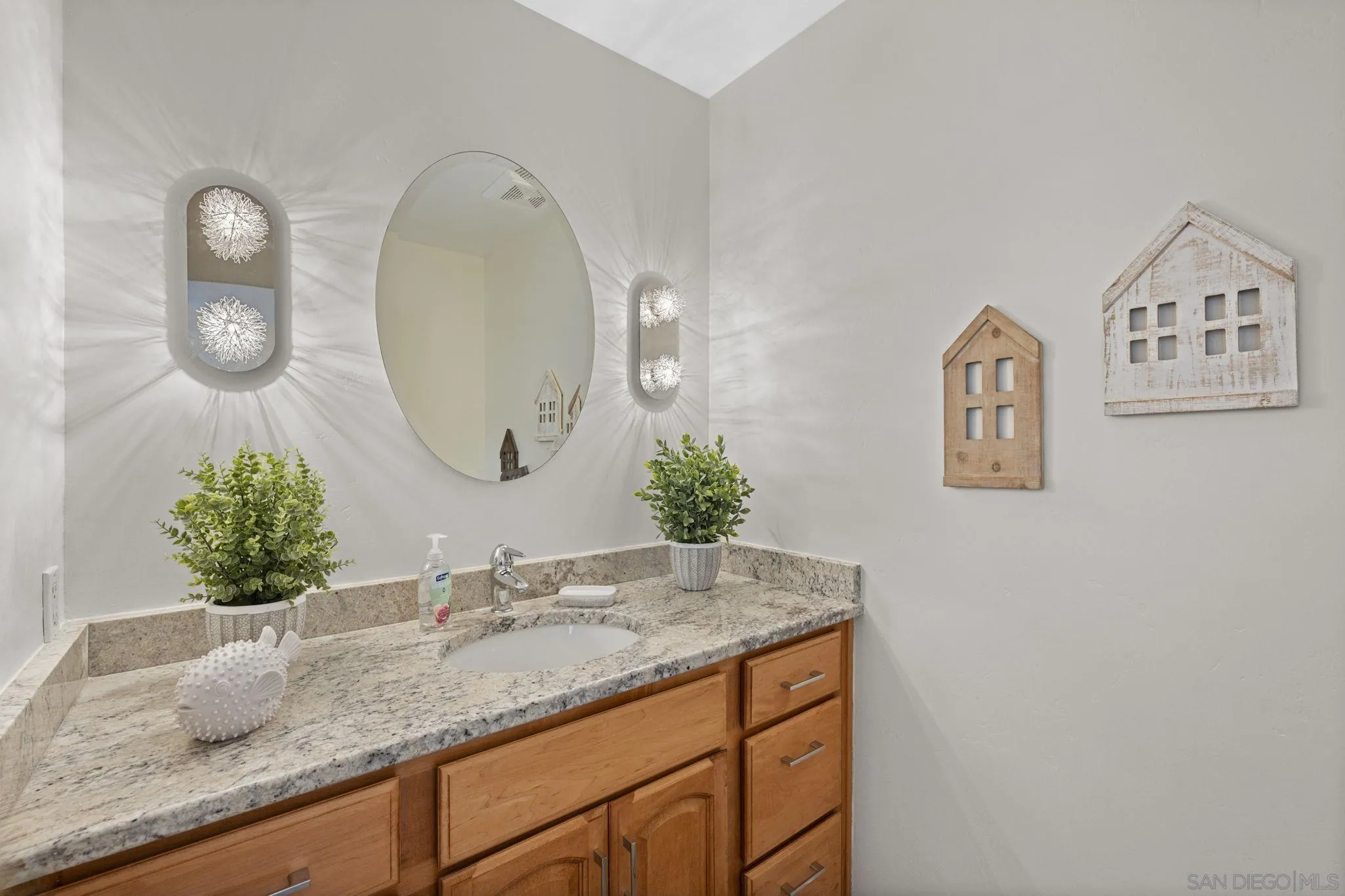 3252 Eichenlaub Street San Diego, CA 92117 - Photo 14 of 36 a bathroom with a granite countertop sink and a mirror