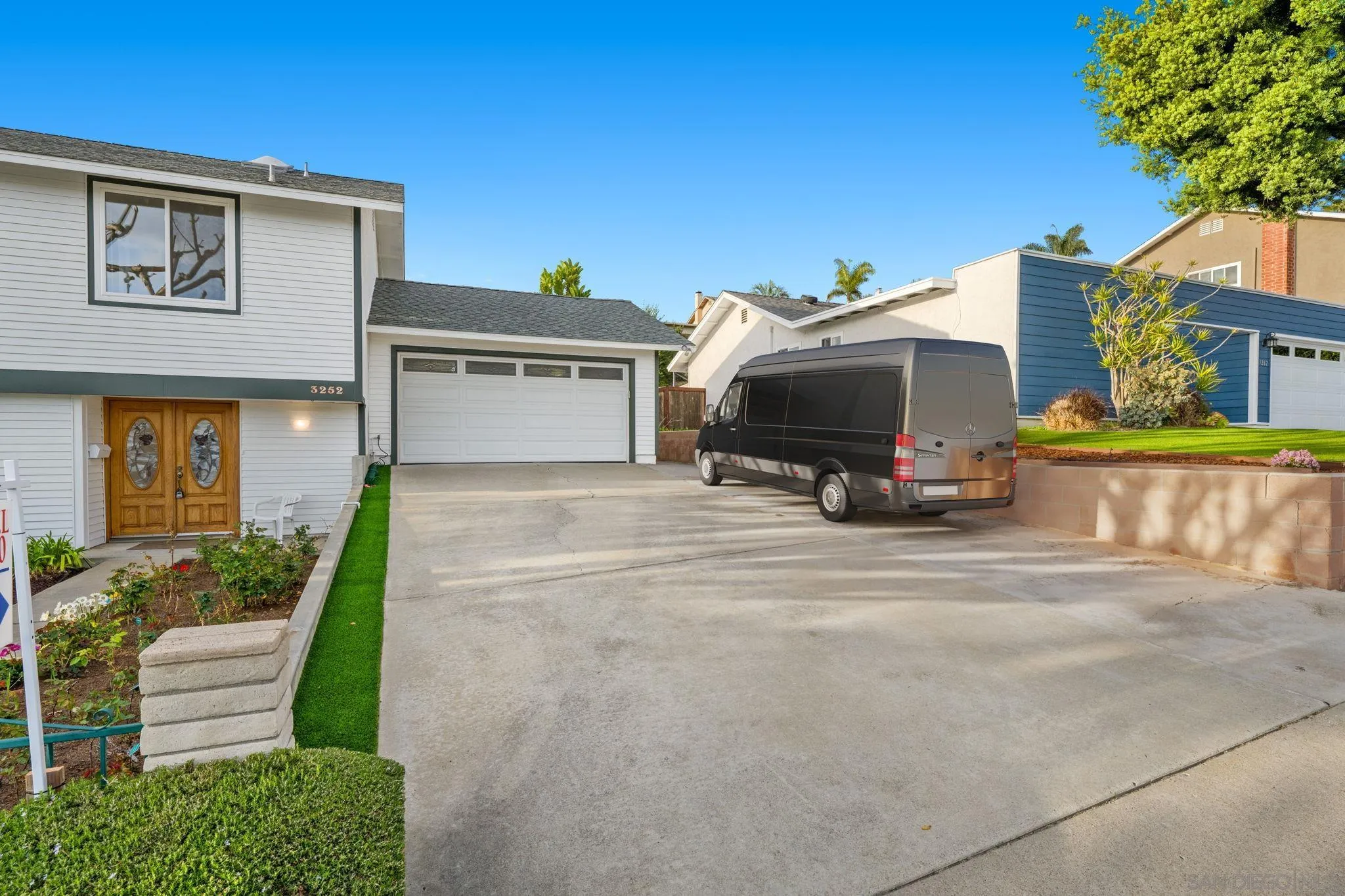 3252 Eichenlaub Street San Diego, CA 92117 - Photo 28 of 36 a front view of a house with a yard