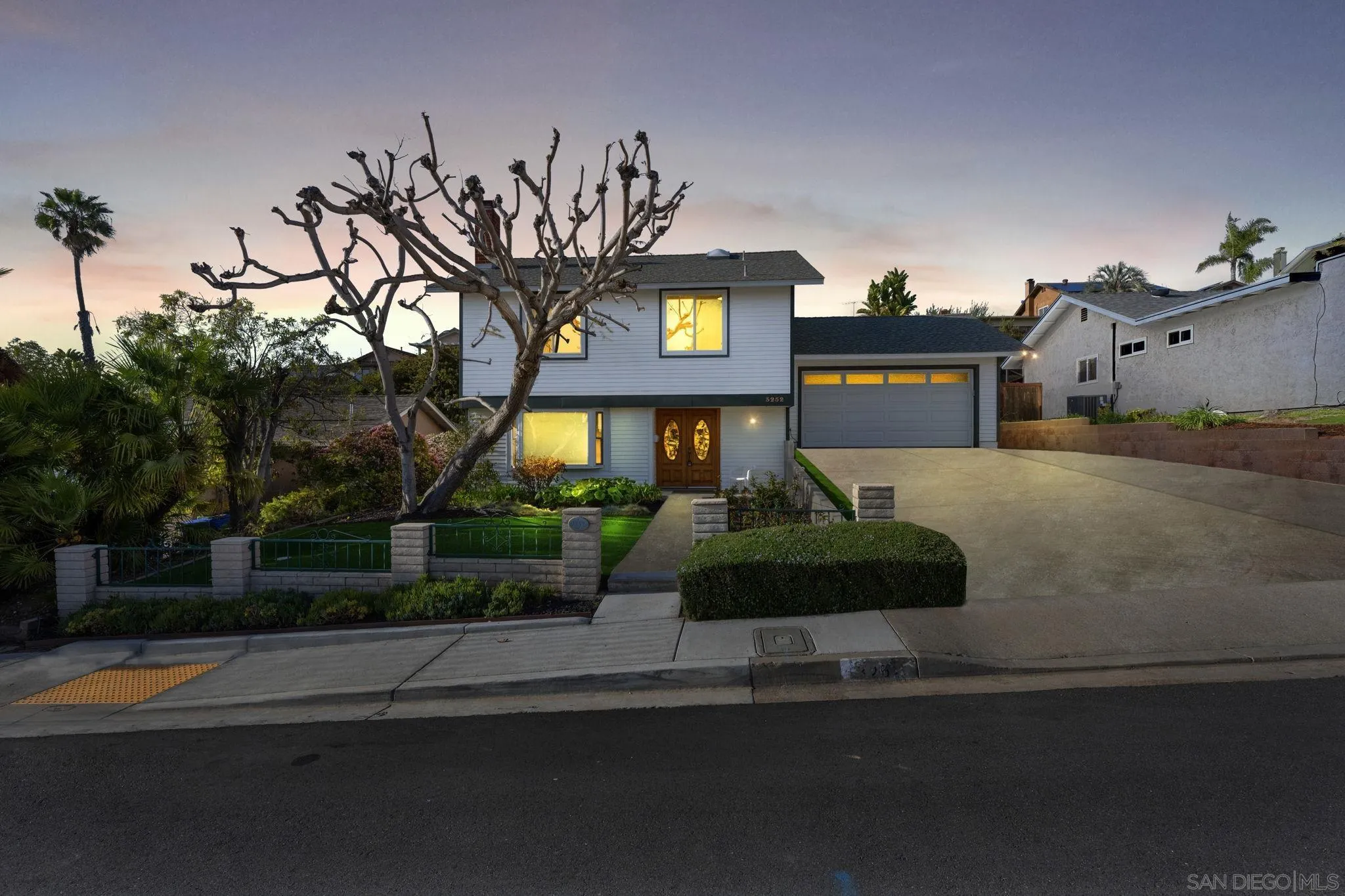 3252 Eichenlaub Street San Diego, CA 92117 - Photo 30 of 36 a front view of a house with garden