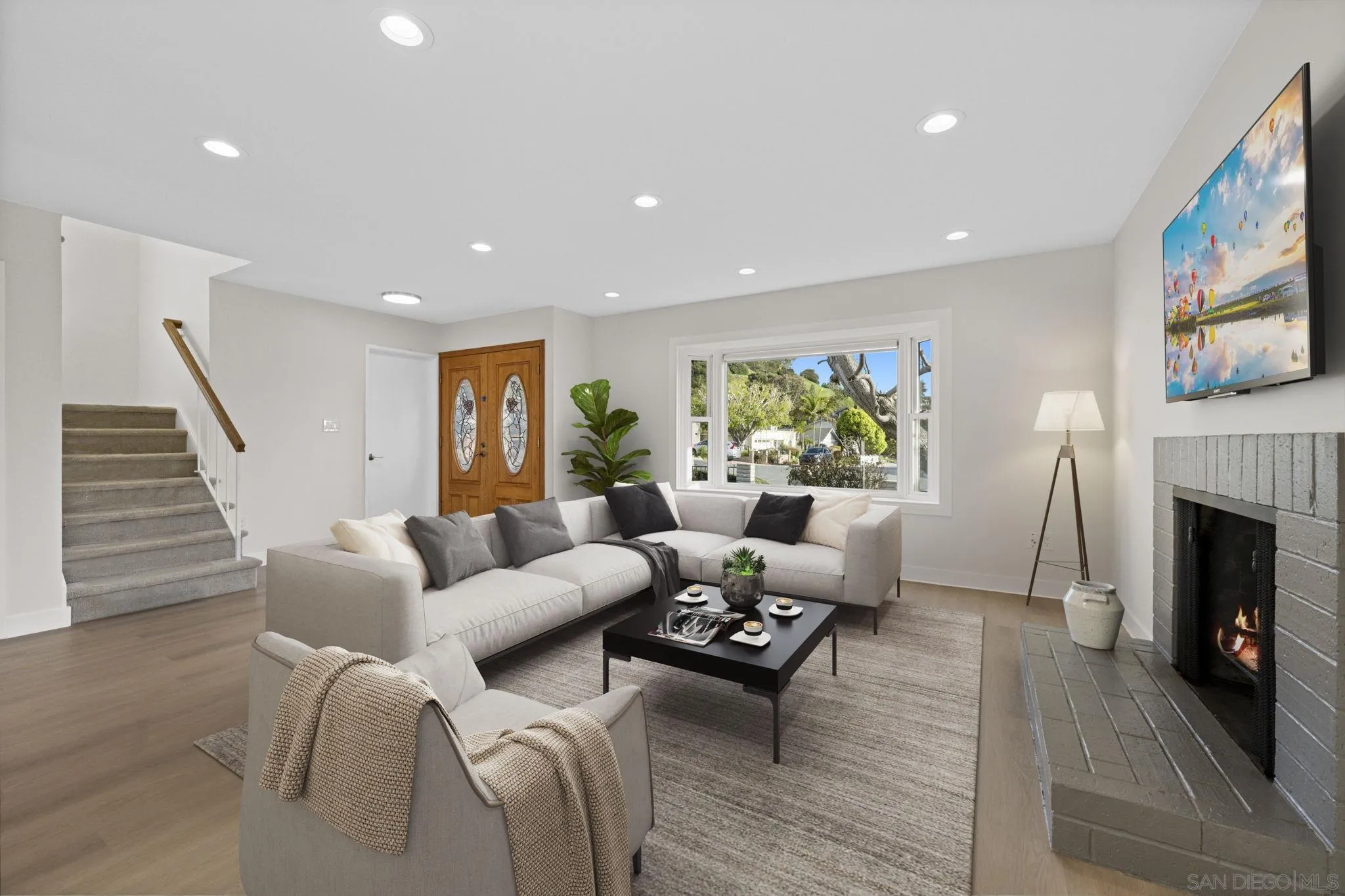 3252 Eichenlaub Street San Diego, CA 92117 - Photo 32 of 36 a living room with furniture and a fireplace