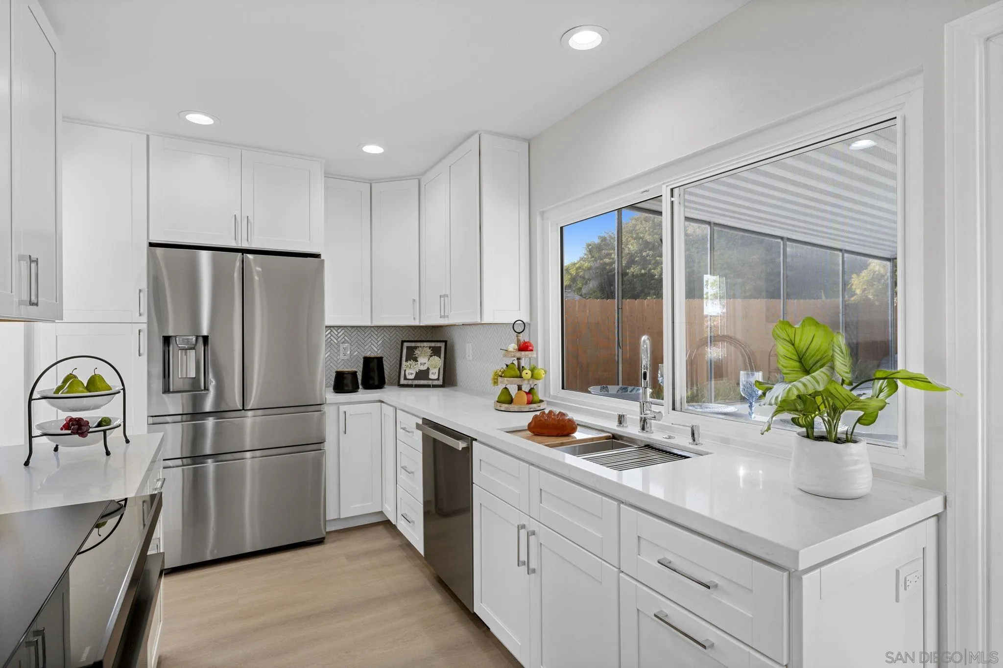 3252 Eichenlaub Street San Diego, CA 92117 - Photo 6 of 36 a kitchen with a sink stainless steel appliances and cabinets