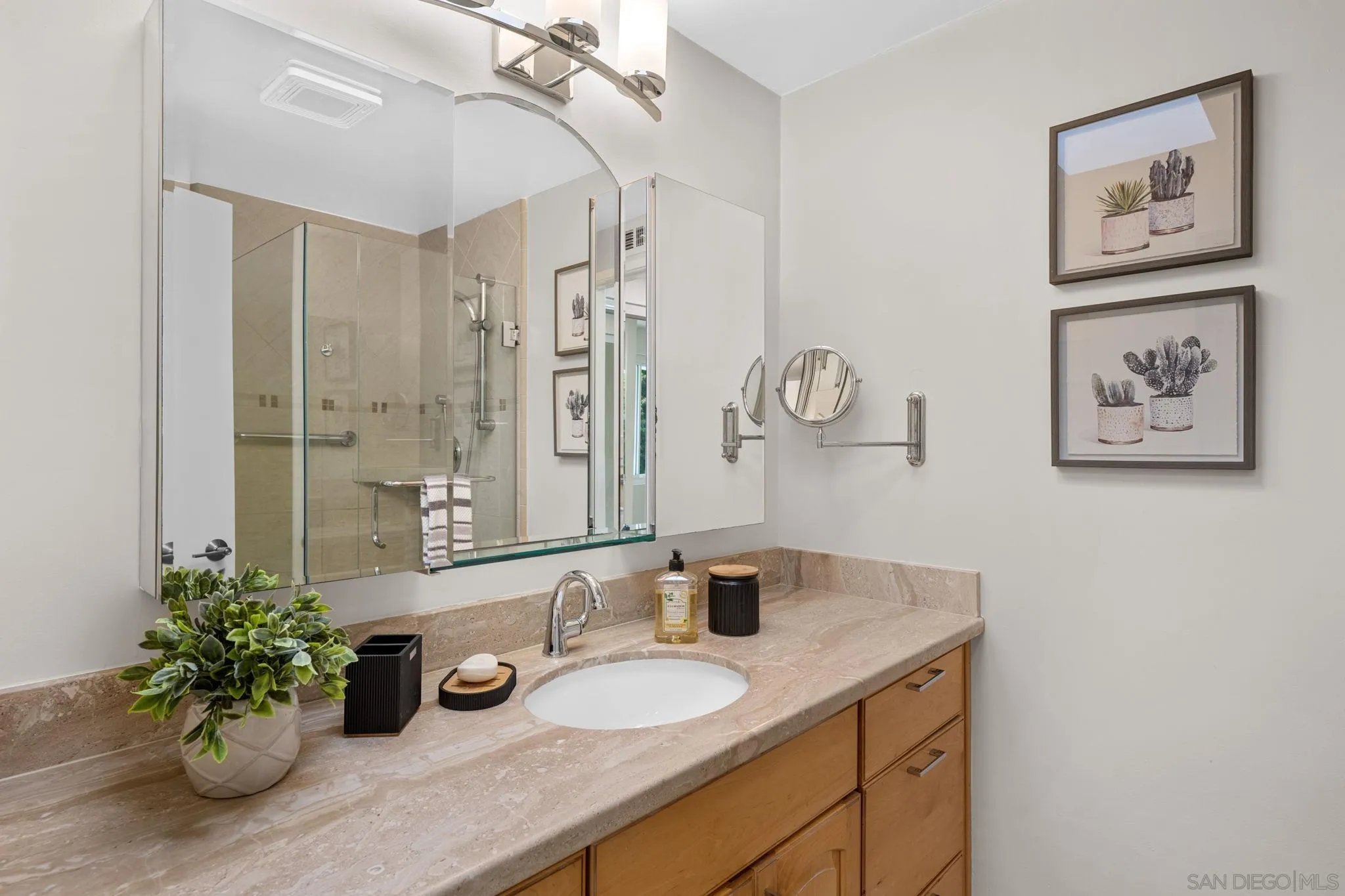 3252 Eichenlaub Street San Diego, CA 92117 - Photo 10 of 36 a bathroom with a granite countertop sink a large mirror and shower