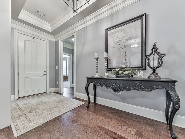 a view of a hallway with wooden floor and workspace